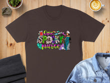 Load image into Gallery viewer, Brown t-shirt with "One Spooky Nurse" graphic featuring medical and Halloween imagery.
