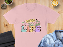 Load image into Gallery viewer, Pink t-shirt with "livin' the LIFE" text and stethoscope graphic.

