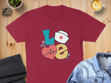 Load image into Gallery viewer, Burgundy t-shirt with "LOVE" graphic featuring medical icons.
