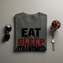 Load image into Gallery viewer, Grey t-shirt with "Eat Sleep Transmit" text, sunglasses, and iced coffee.
