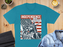Load image into Gallery viewer, Statue of Liberty and American flag graphic on a teal t-shirt.
