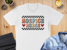 Load image into Gallery viewer, White t-shirt with "HOSPICE NURSE" in colorful retro lettering and checkered pattern.
