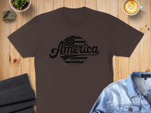 Load image into Gallery viewer, Brown t-shirt with "America EST. 1776" text and distressed flag graphic.
