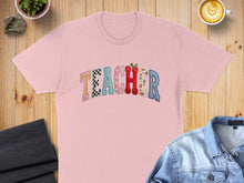 Load image into Gallery viewer, Pink t-shirt with "TEACHER" text in colorful, patterned alphabet blocks.
