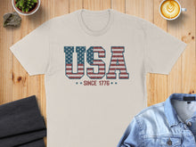 Load image into Gallery viewer, Beige t-shirt with "USA SINCE 1776" in distressed American flag print.
