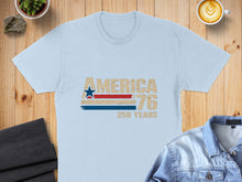 Load image into Gallery viewer, Light blue t-shirt with "AMERICA 76 250 YEARS" graphic.
