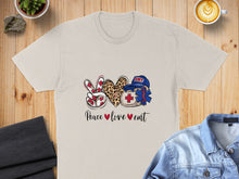 Load image into Gallery viewer, Cream t-shirt with "Peace love  EMT" text and medical cross, heart, and peace sign graphics.
