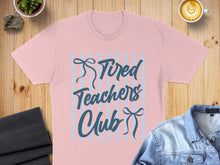 Load image into Gallery viewer, Light pink t-shirt with "Tired Teachers Club" text and blue stripes.
