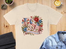 Load image into Gallery viewer, Cream t-shirt with "USA" in American flag colors, surrounded by flowers and "250 Years of Freedom".
