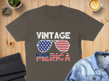 Load image into Gallery viewer, Brown t-shirt with "VINTAGE AMERICA" and flag sunglasses design.
