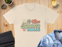 Load image into Gallery viewer, Cream t-shirt with "One Badass Nurse" text in retro floral font.
