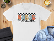 Load image into Gallery viewer, White t-shirt with "Nurse Love Inspire Heal" text and checkered border.
