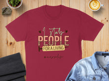 Load image into Gallery viewer, Maroon t-shirt with text "I stab people for a living #nurselife".
