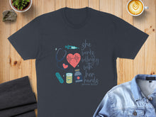 Load image into Gallery viewer, Dark grey t-shirt with "she works willingly with her hands" text and medical icons.
