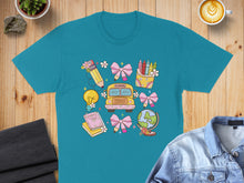 Load image into Gallery viewer, School-themed illustration with bus, books, pencils, globe, and lightbulb on teal t-shirt.
