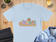 Load image into Gallery viewer, Light blue t-shirt with "NURSE" in colorful retro font with flowers.
