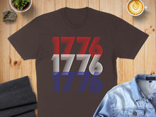 Load image into Gallery viewer, Brown t-shirt with "1776" repeated in red, white, and blue stripes.
