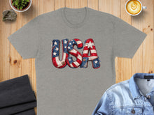 Load image into Gallery viewer, Grey t-shirt with "USA" in patriotic flag-themed lettering.
