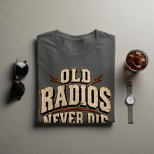 Load image into Gallery viewer, Grey t-shirt with "OLD RADIOS NEVER DIE" text and lightning bolts.
