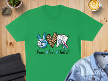 Load image into Gallery viewer, Green t-shirt with peace sign, leopard print heart, tooth, and dental tools.
