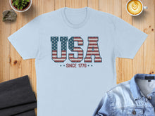 Load image into Gallery viewer, Light blue t-shirt with "USA SINCE 1776" in distressed American flag design.
