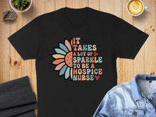 Load image into Gallery viewer, Black t-shirt with colorful floral "It takes a lot of sparkle to be a hospice nurse" text.
