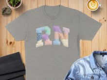 Load image into Gallery viewer, Gray t-shirt featuring colorful patchwork "RN" text.
