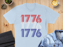 Load image into Gallery viewer, Light blue t-shirt with red, white, and blue "1776" graphic.
