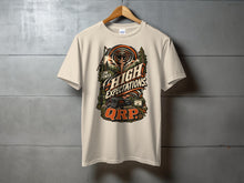 Load image into Gallery viewer, T-shirt with graphic featuring ham radio equipment and "Low Power High Expectations QRP" text.
