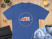 Load image into Gallery viewer, Blue t-shirt with graphic of an ambulance and text "Hot Girls Hit Curbs".
