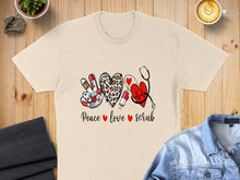 Load image into Gallery viewer, "Peace love scrub" text with a stethoscope and heart design on a t-shirt.
