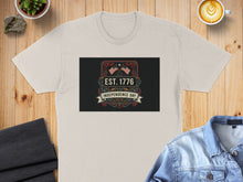 Load image into Gallery viewer, Beige t-shirt featuring "EST. 1776 Independence Day" with American flags and decorative banners.
