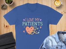 Load image into Gallery viewer, Blue t-shirt with "I love my patients" and heart/stethoscope graphic.

