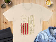 Load image into Gallery viewer, Cream t-shirt with distressed American flag and "We The People" text.
