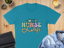 Load image into Gallery viewer, Teal t-shirt with "Nurse Life" text and a syringe graphic.
