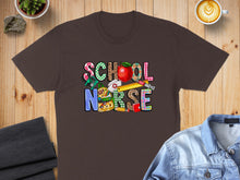 Load image into Gallery viewer, Brown t-shirt with "SCHOOL NURSE" text featuring school supplies and apple graphic.
