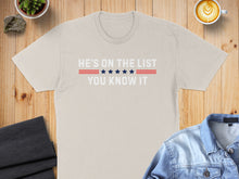 Load image into Gallery viewer, Beige t-shirt with text "He's on the list you know it" and red and blue stripes.
