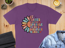 Load image into Gallery viewer, Purple t-shirt with colorful text and flower graphic: "It takes a lot of sparkle to be a hospice nurse."
