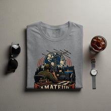 Load image into Gallery viewer, Grey t-shirt with "AMATEUR" graphic depicting radio operator, equipment, and globe.
