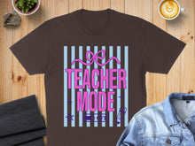 Load image into Gallery viewer, Brown t-shirt with "Teacher Mode On" text and pink bow design.
