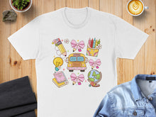 Load image into Gallery viewer, White t-shirt with colorful school-themed doodles including a bus, globe, and crayons.
