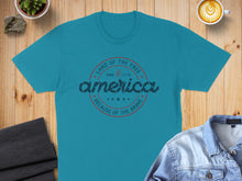 Load image into Gallery viewer, Teal t-shirt with "Land of the Free, Since 1776, America, Because of the Brave" text.
