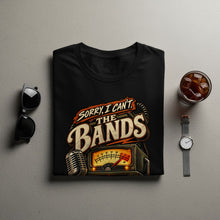 Load image into Gallery viewer, Black t-shirt with "Sorry, I Can't The Bands" text, vintage microphone, and radio graphic.
