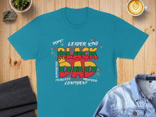 Load image into Gallery viewer, Black Dad text design with supportive, fearless, confident elements on a teal t-shirt.
