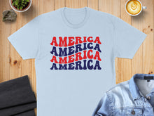 Load image into Gallery viewer, Light blue t-shirt with "AMERICA AMERICA AMERICA" text in red and blue.
