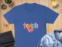 Load image into Gallery viewer, Blue t-shirt with colorful "Teach" text and a pink bow.
