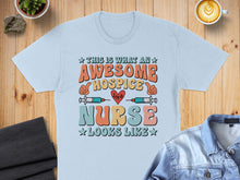 Load image into Gallery viewer, Awesome Hospice Nurse graphic with heart and stethoscope on light blue t-shirt.
