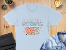 Load image into Gallery viewer, Light blue t-shirt with "I Love My Patients" text, heart, and stethoscope.

