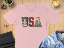 Load image into Gallery viewer, Pink t-shirt with "USA" in distressed flag print and skyline graphic.
