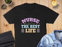 Load image into Gallery viewer, Black t-shirt with text "Nurse is the best life" in colorful block letters.
